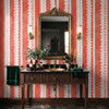 Dark vintage dresser with pink lace stripe wallpaper and ornate mirror