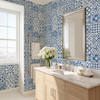 Blue Moroccan geometric wallpaper covering bathroom walls with light wood vanity, 26-inch repeat