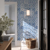 Blue Moroccan tile wallpaper on entryway accent wall with rattan basket, 26-inch repeat