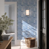 Blue geometric Moroccan wallpaper on narrow entryway wall with rattan basket, 13-inch repeat