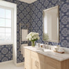 Blue French country tile wallpaper in 26-inch pattern scale in a bathroom with light wood vanity and mirror