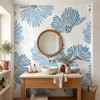 Linnea Blue Watercolor Floral Wallpaper in a bathroom with wood vanity, round mirror, and large-scale Nordic blue floral pattern