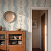 Elsie Heritage Blue floral stripe wallpaper in 52 inch repeat styled in a French country dining room with wood cabinet, doorway, straw hat, and soft blue botanical stripes