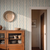 Elsie Heritage Blue floral stripe wallpaper in 26 inch repeat styled in a French country dining room with wood cabinet, doorway, straw hat, and vintage blue floral stripe wall
