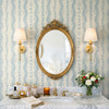 Elsie Heritage Blue floral stripe wallpaper in 26 inch repeat styled in a bathroom vanity with gold mirror, brass sconces, marble counter, and blue floral stripe wall
