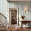 Elsie Heritage Blue floral stripe wallpaper in 26 inch repeat styled in an entryway staircase with wood console table, wall sconce, flowers, and French country decor