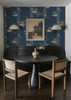 Fruit Compote Navy Blue retro dining room wallpaper in 26 inch repeat styled in a breakfast nook with black round table, wall sconces, and vintage framed art