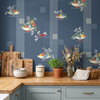 Fruit Compote Navy Blue retro kitchen wallpaper in 52 inch repeat styled with blue cabinets, wood counter, cutting boards, plants, and vintage kitchen decor