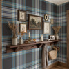 Navy and teal plaid wallpaper in a hallway with wood console table, framed art, baskets, and lodge style accents 52 REPEAT
