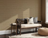 0446 Brown Faux Linen Wallpaper styled in a neutral living room with bench seating, pillows, side table, woven pouf, and warm textured wall pattern