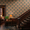 Small scale Alderley Tulip Wallpaper on a staircase wall with dark wood trim, warm lamp light, and heritage Arts and Crafts style