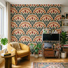 Alderley Tulip Wallpaper in a maximalist living room with mustard chair, plants, and terracotta green botanical pattern