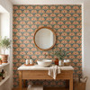 Alderley Tulip Wallpaper in a bathroom with wood vanity, round mirror, terracotta flowers, and green botanical pattern