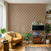 Small scale Alderley Tulip Wallpaper in a maximalist living room with mustard chair, plants, and warm vintage decor