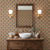 Alderley Tulip Wallpaper in a bathroom with dark wood vanity, square mirror, brass sconces, and terracotta green floral pattern