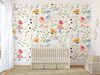 Eloise Wildflower Wallpaper styled in a bright nursery with white crib, soft rug, window light, and cheerful watercolor wildflower wall pattern