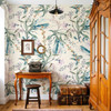 Eden Watercolor Floral Wallpaper styled in a vintage entryway with wood desk, mirror, trunk, warm wood door, teal leaves, lavender flowers, and boho botanical wall decor
