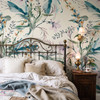 Eden Watercolor Floral Wallpaper styled in a Victorian bedroom with brass bed, wood nightstand, layered bedding, wall sconce, and large botanical floral wallpaper