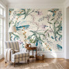 Eden Watercolor Floral Wallpaper styled in a bright living room with striped chairs, round table, natural light, and soft botanical wall mural
