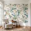Eden Watercolor Floral Wallpaper styled in a bright living room with striped chairs, round table, natural light, and oversized watercolor floral wall mural