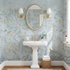 Blue woodland bird wallpaper with flowering trees in a vintage bathroom