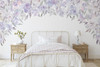 Lavender floral canopy wall decal with soft purple blush and green flowers framing a white metal bed in a girls bedroom