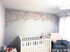Delaney Jasmin pink floral canopy wall decal installed wall to wall above a white crib in a real nursery