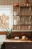 Elsie Sunbaked Clay wallpaper above a farmhouse kitchen counter and open shelves, 26 inch repeat