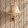 Small-scale Elsie Sunbaked Clay floral stripe wallpaper with a brass wall sconce, 13 inch repeat