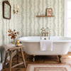 Large-scale Elsie Ivory Sage floral stripe wallpaper behind a freestanding bathtub, 52 inch repeat