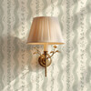 Delicate Elsie Ivory Sage floral stripes surrounding a brass wall sconce, 13 inch repeat