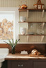Small-scale Elsie Ivory Sage floral stripe wallpaper shown in a kitchen close-up, 13 inch repeat