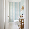 Elsie Aquamarine teal and ivory wallpaper in a bathroom viewed through an open doorway, 26 inch repeat
