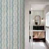 Elsie Aquamarine light teal flowers and leafy stripes beside a bathroom doorway, 26 inch repeat