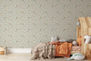 Small-scale sage green goose wallpaper in a cozy cottage kids bedroom with a wooden house bed, shown in the 26-inch repeat