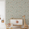 Sage green goose wallpaper in a cottage nursery play area with a white cabinet, wooden toys and giraffe, shown in the 26-inch repeat