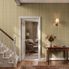 Small-scale Elsie Walnut and Butter botanical stripe wallpaper in a traditional entry hall with a staircase and antique console table