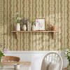 Large-scale brown botanical stripe wallpaper above white wainscoting in a cheerful cottage kitchen dining area