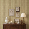 Small-scale Elsie Walnut and Butter heritage wallpaper behind an antique dresser with vintage portraits and collected accessories