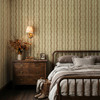 Small-scale Elsie Walnut and Butter stripe wallpaper in a cozy vintage bedroom with dark bedding, warm wood and brass lighting