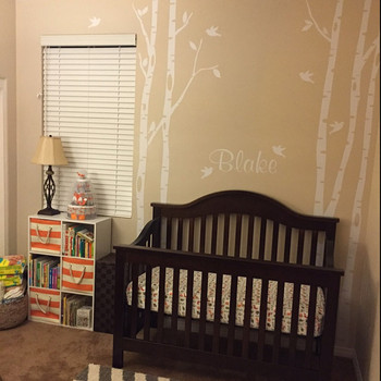 Personalized white birch tree wall decals with birds and the name Blake in a neutral baby nursery