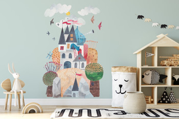 Large pastel fairytale castle mountain wall decal displayed above a black metal crib on a dark green nursery wall