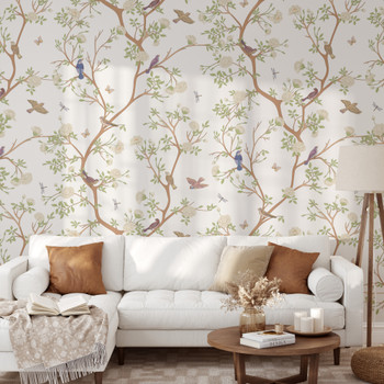 Bird and blossom chinoiserie wallpaper styled in a neutral living room with white sofa