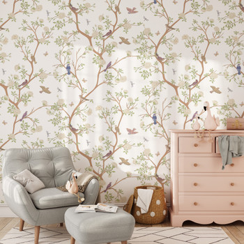 Chinoiserie wallpaper with birds and blossoming branches styled in a soft girls room with blush dresser