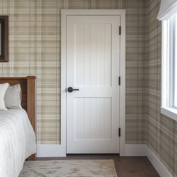Neutral beige plaid wallpaper in 26 inch repeat styled in a cozy bedroom with white paneled door, wood bed, and farmhouse cottage decor
