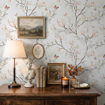 Magnolia Chinoiserie Wallpaper styled with rustic wood dresser, table lamp, framed art, candles, and soft botanical floral wall decor