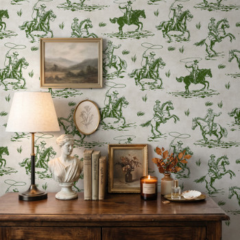 Weathered Green Cowboy Wallpaper styled with rustic wood dresser, table lamp, framed art, candles, and vintage Western cowboy wall decor