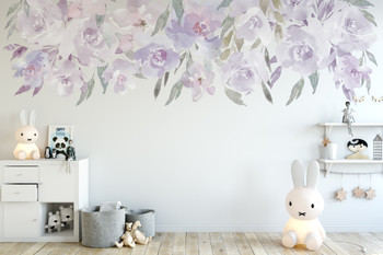 Lavender floral border wall decal with watercolor flowers above a nursery wall in soft blush, purple and green tones