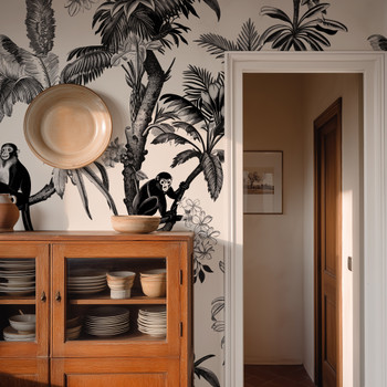 Vintage tropical wallpaper in entryway with monkeys, palm trees and warm wood furniture