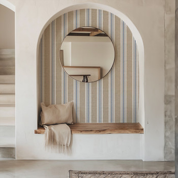 Coastal blue and tan vertical stripe wallpaper styled in a welcoming entryway at the 26-inch pattern scale